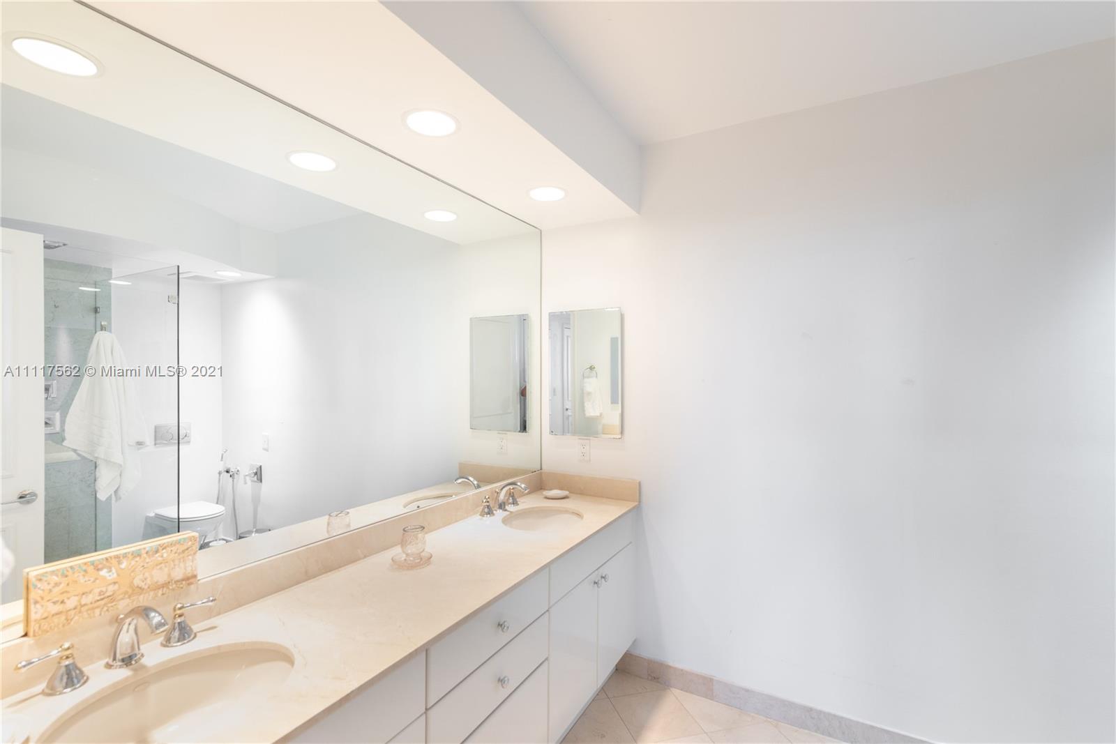 765 Crandon Boulevard, Unit 504 Key Biscayne, FL 33149 - Photo 14 of 46 a bathroom with a sink and a mirror