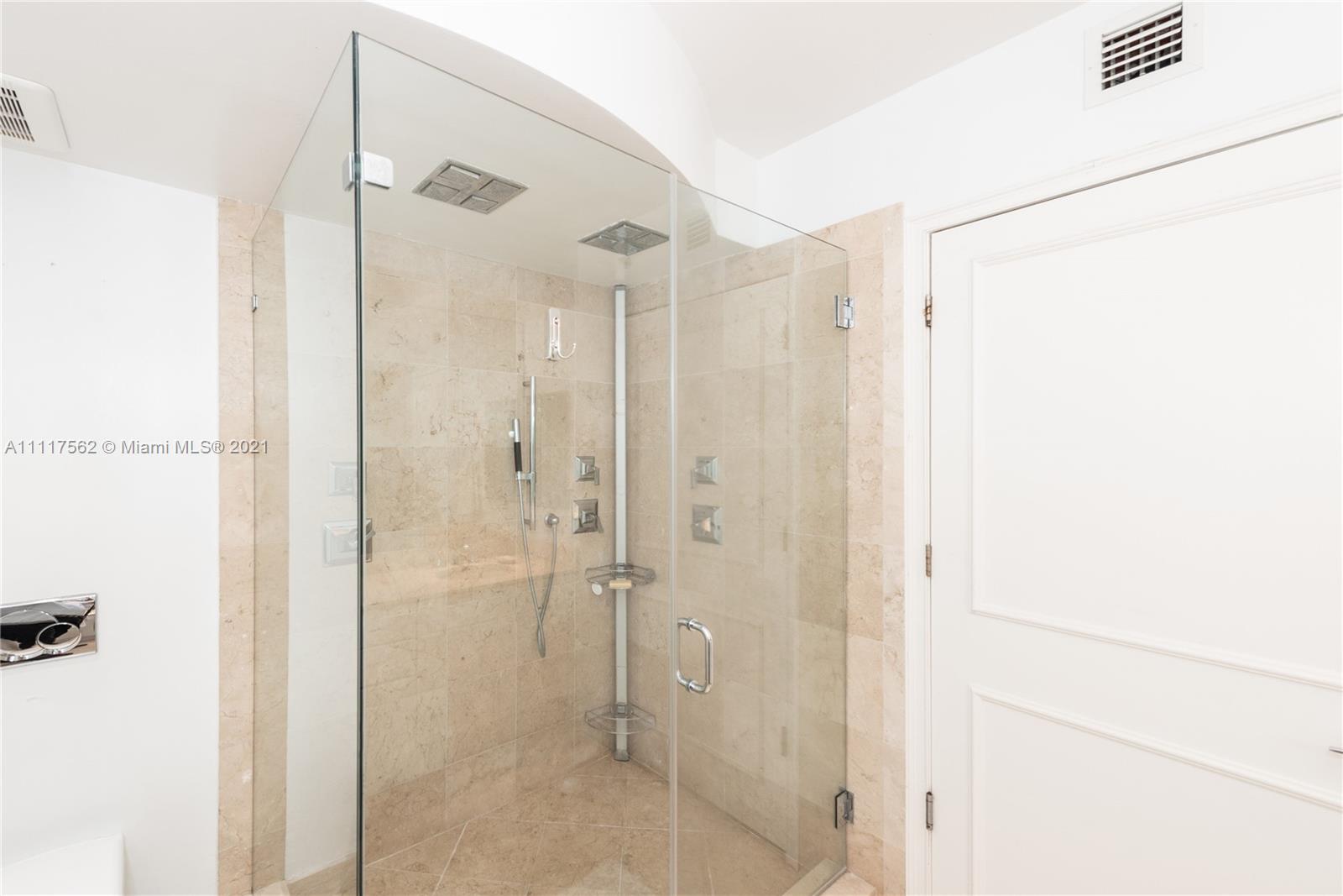 765 Crandon Boulevard, Unit 504 Key Biscayne, FL 33149 - Photo 15 of 46 a bathroom with a shower and a glass door
