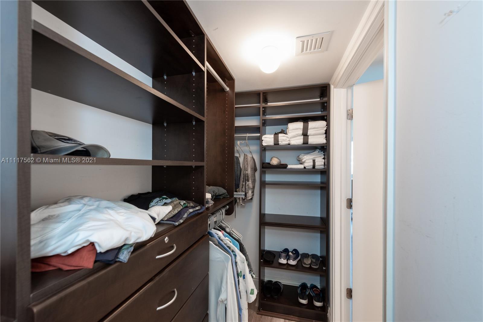 765 Crandon Boulevard, Unit 504 Key Biscayne, FL 33149 - Photo 16 of 46 a kitchen with a refrigerator and cabinets