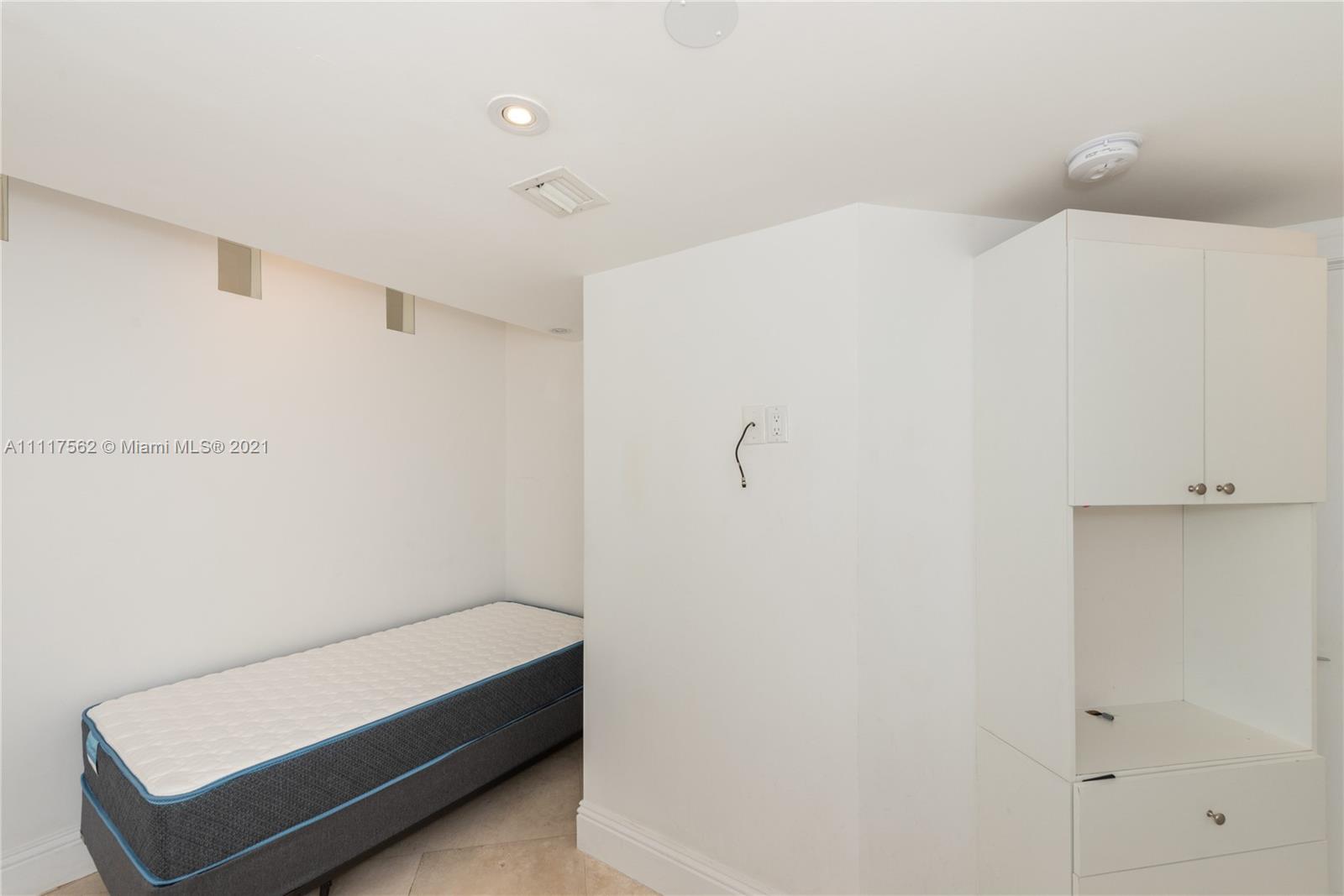 765 Crandon Boulevard, Unit 504 Key Biscayne, FL 33149 - Photo 21 of 46 a bedroom with a bed and a shower