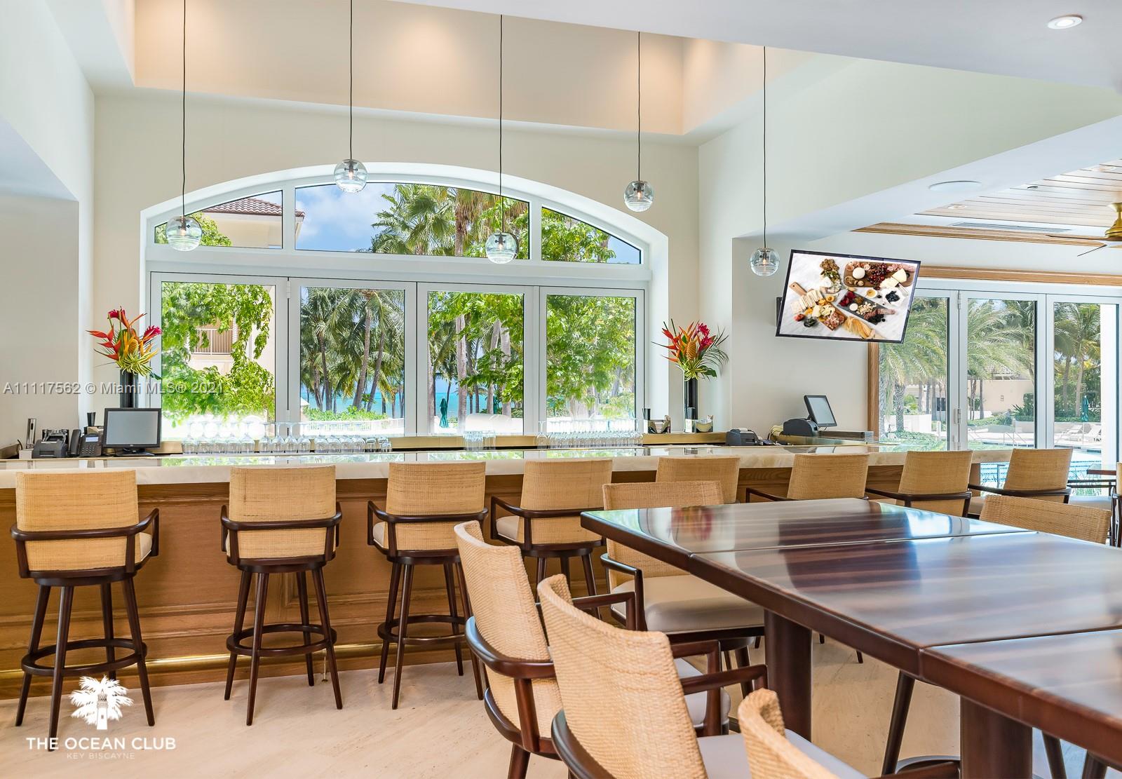 765 Crandon Boulevard, Unit 504 Key Biscayne, FL 33149 - Photo 34 of 46 a dining room with furniture a chandelier and wooden floor
