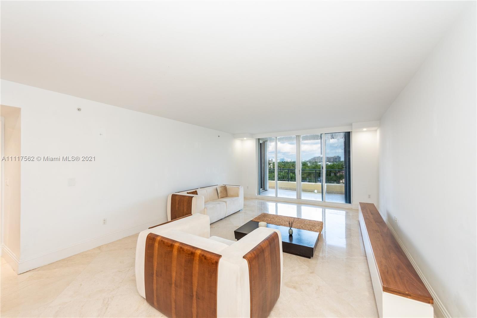 765 Crandon Boulevard, Unit 504 Key Biscayne, FL 33149 - Photo 5 of 46 a room with a bed and a large window