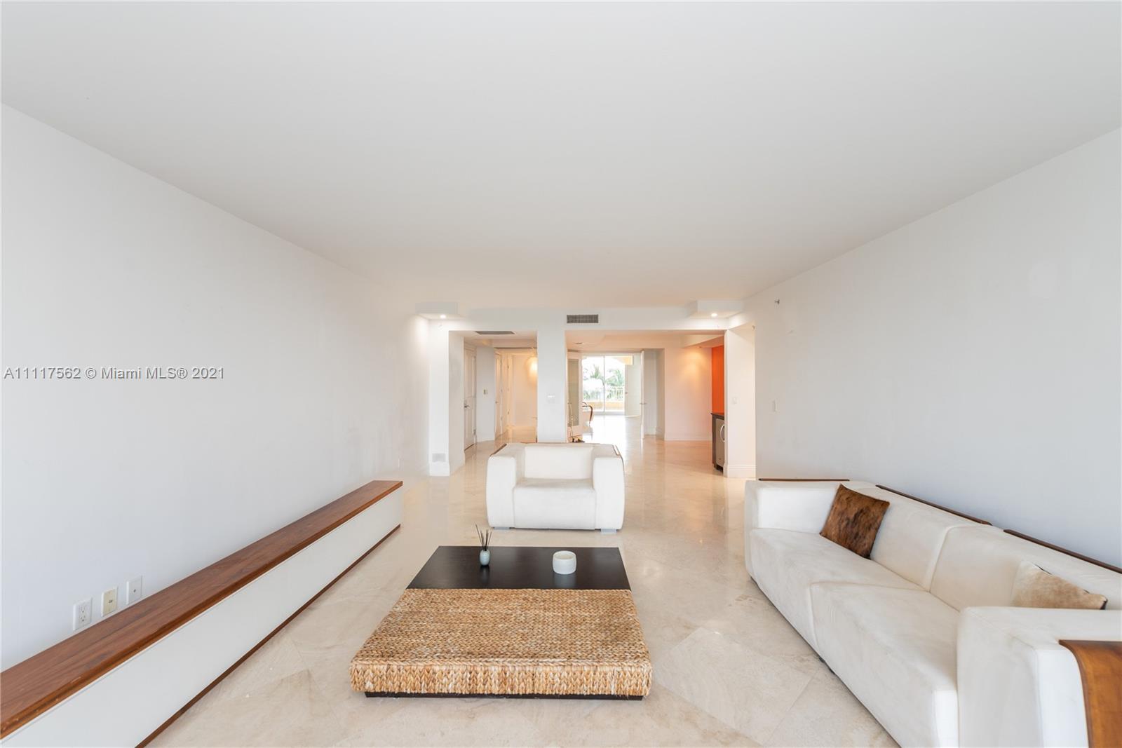 765 Crandon Boulevard, Unit 504 Key Biscayne, FL 33149 - Photo 6 of 46 a living room with furniture and large windows