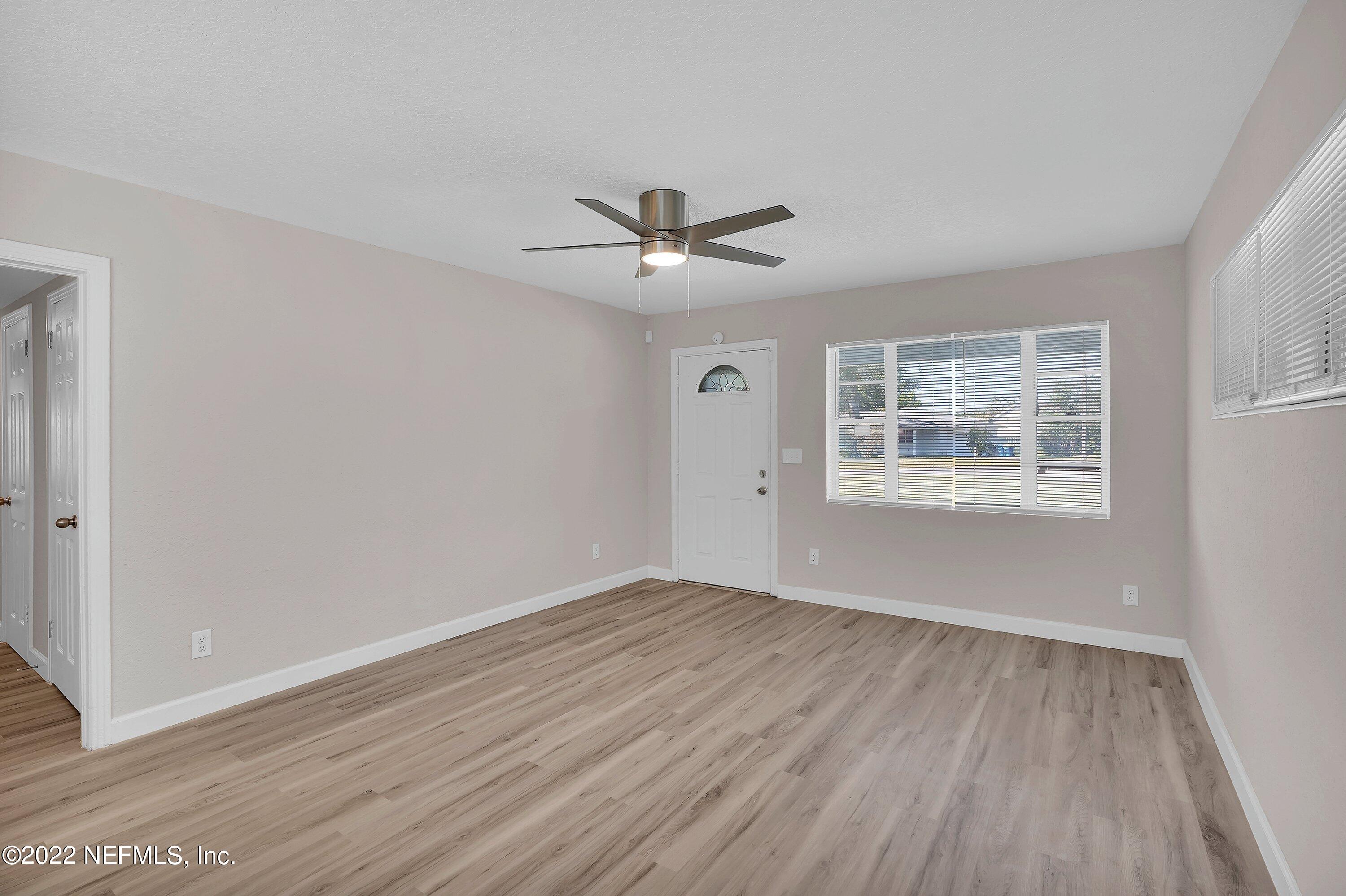 6631 Champlain Road Jacksonville, FL 32208 - Photo 7 of 25 wooden floor in an empty room with a window