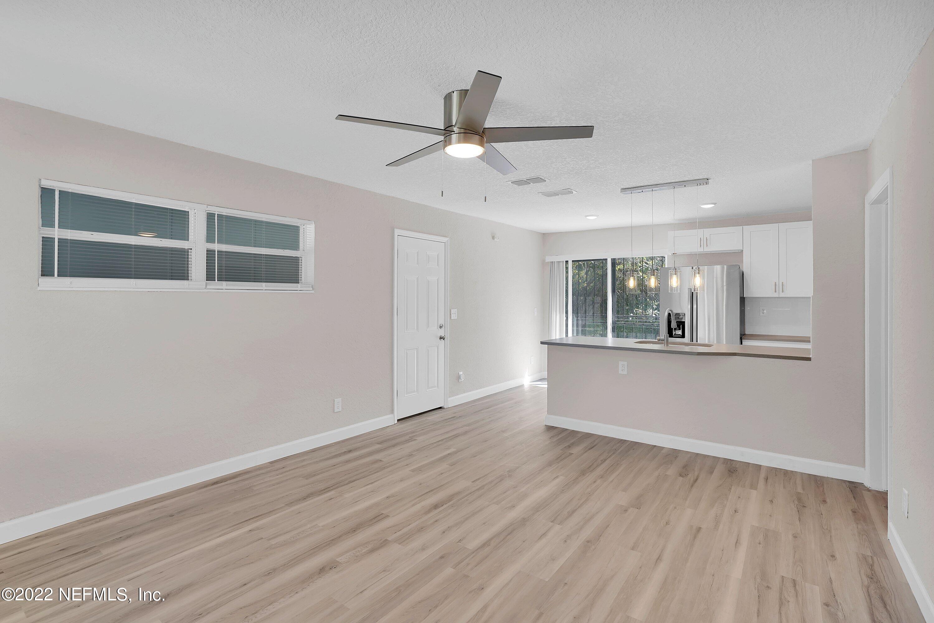 6631 Champlain Road Jacksonville, FL 32208 - Photo 8 of 25 a view of workspace with wooden floor and windows