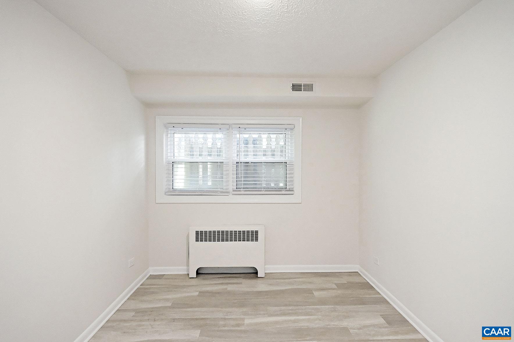 616 Rockcreek Road, Unit B Charlottesville, VA 22903 - Photo 6 of 13 a view of a livingroom with wooden floor and a window