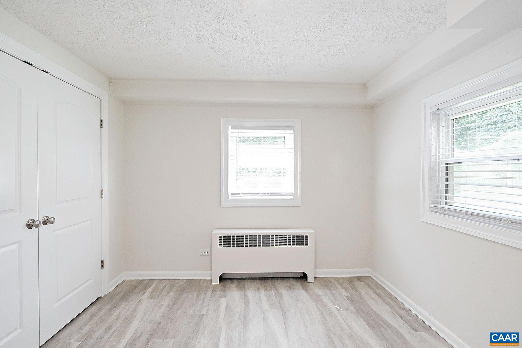 616 Rockcreek Road, Unit B Charlottesville, VA 22903 - Photo 8 of 13 a view of a room with wooden floor and a window