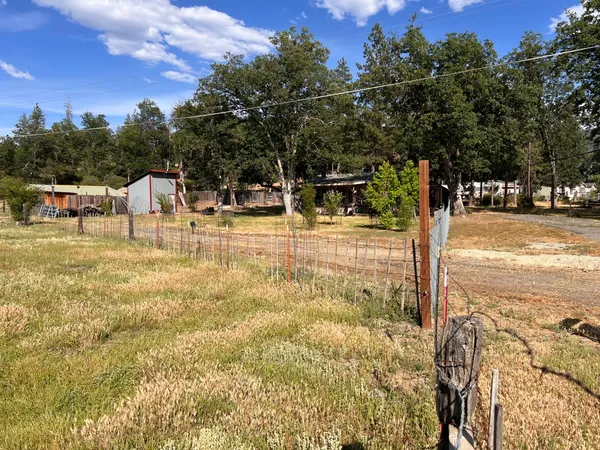 a view of a swimming pool with a lawn chairs and floor to ceiling window