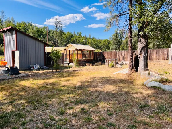 a view of a house with yard and sitting area