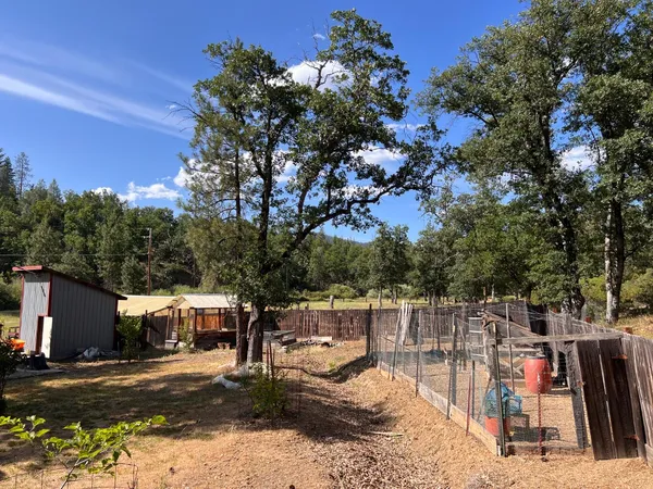 a view of a house with wooden fence
