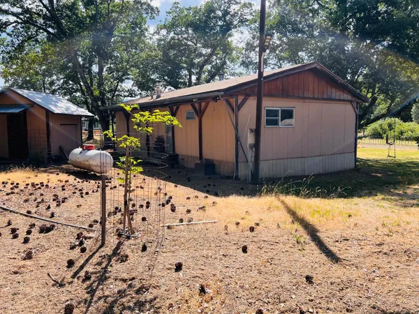 a backyard of a house with table and chairs