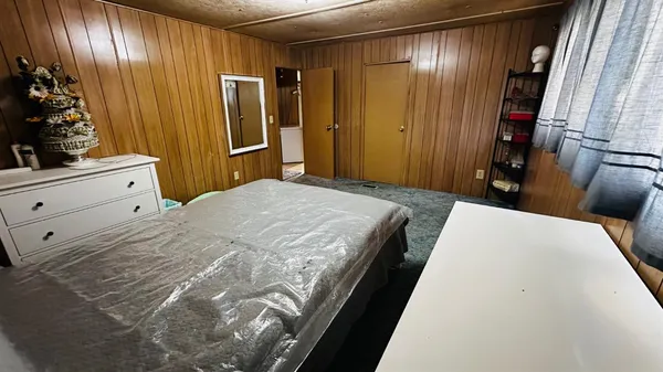 a bathroom with a toilet and a mirror