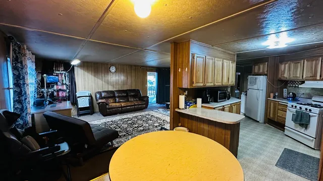 a kitchen with stainless steel appliances a stove a sink dishwasher and wooden cabinets