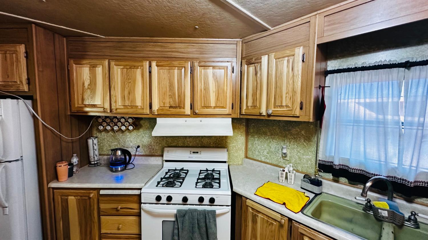 70 Oak Avenue Hayfork, CA 96041 - Photo 41 of 49 a kitchen with a stove a sink and cabinets