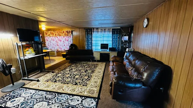a utility room with dryer washer and a view of living room