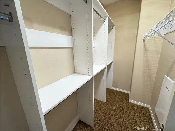 a view of hallway with stairs and wooden floor