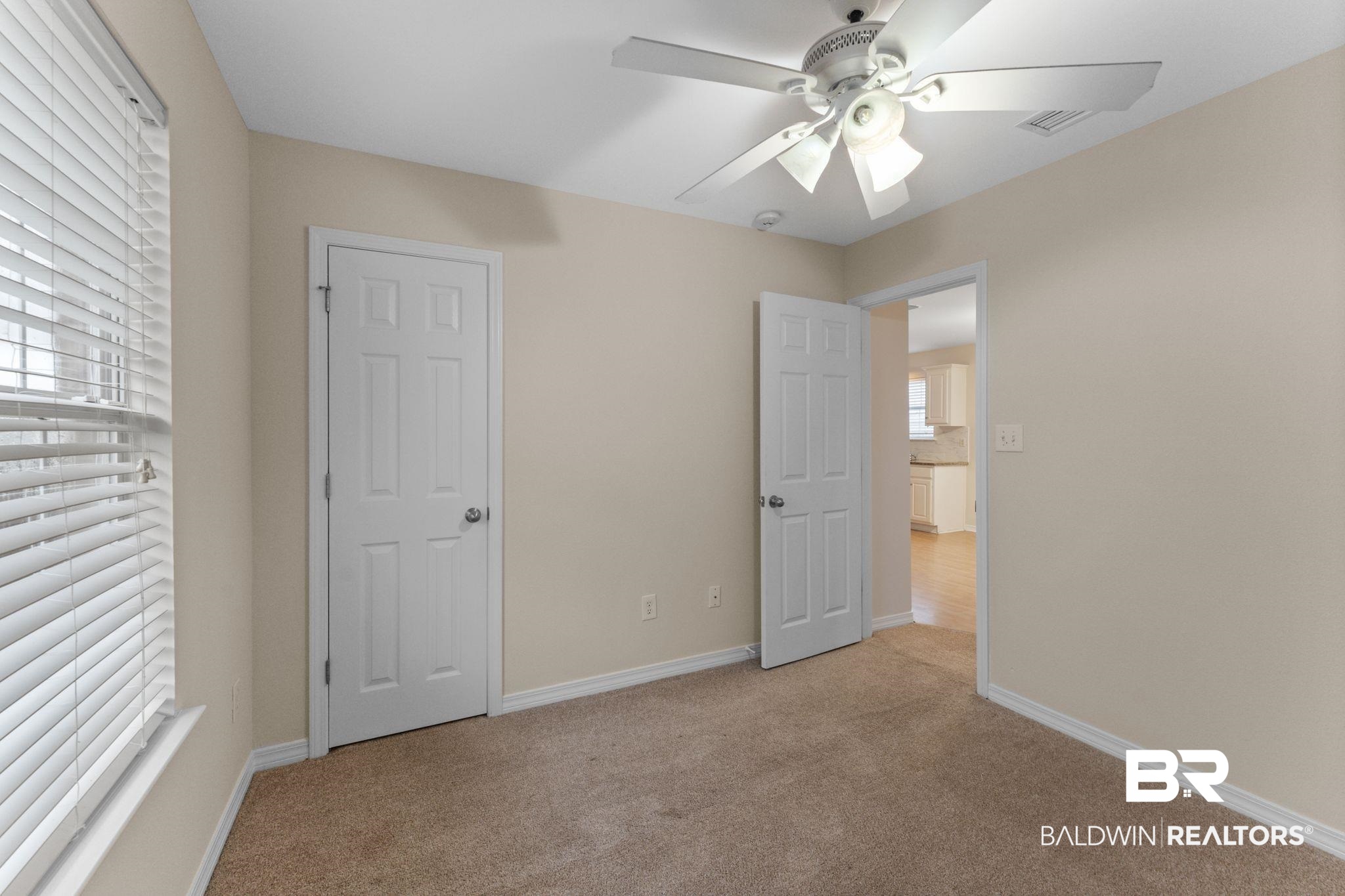 4009 Kendallbrook Loop Foley, AL 36535 - Photo 16 of 28 Unfurnished bedroom featuring light carpet and a ceiling fan