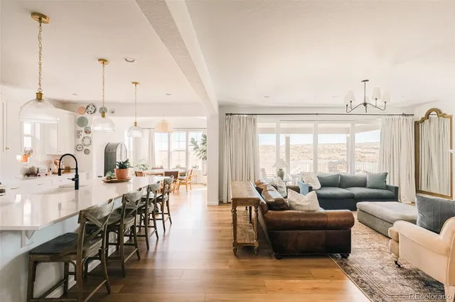 a living room with furniture wooden floor and a large window