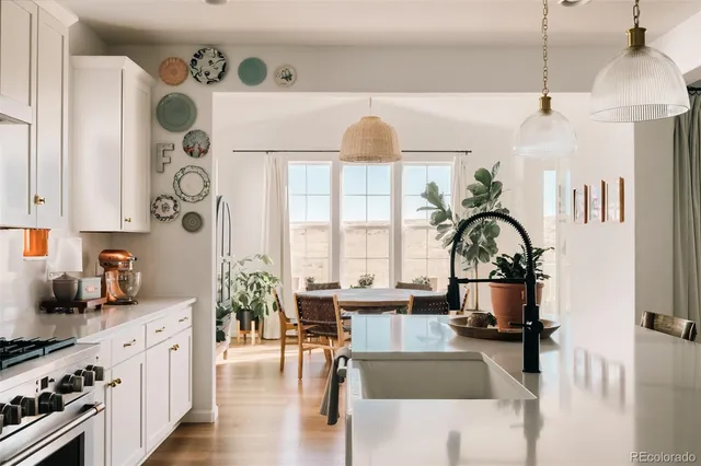 a living room with furniture a fireplace and potted plants