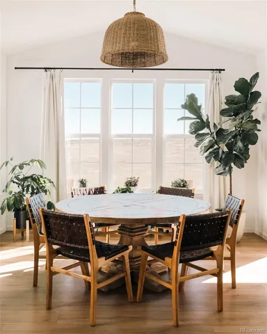 a dining room with furniture and wooden floor