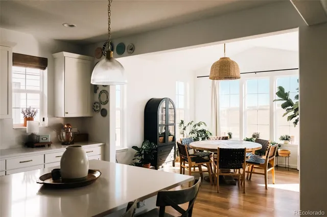 a dining room with furniture a window and wooden floor