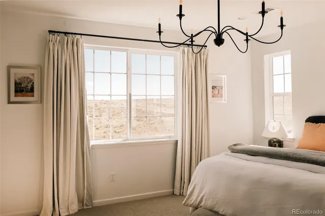 a bedroom with a bed next to a window