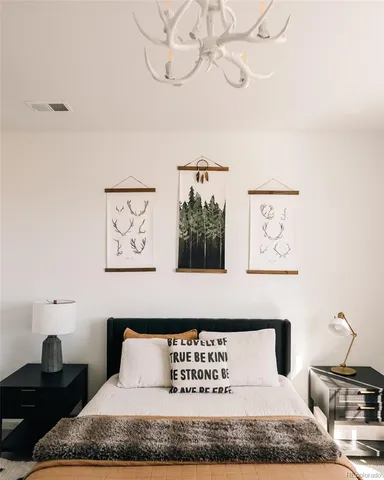 a black leather couch sitting next to a white cabinet and cabinet