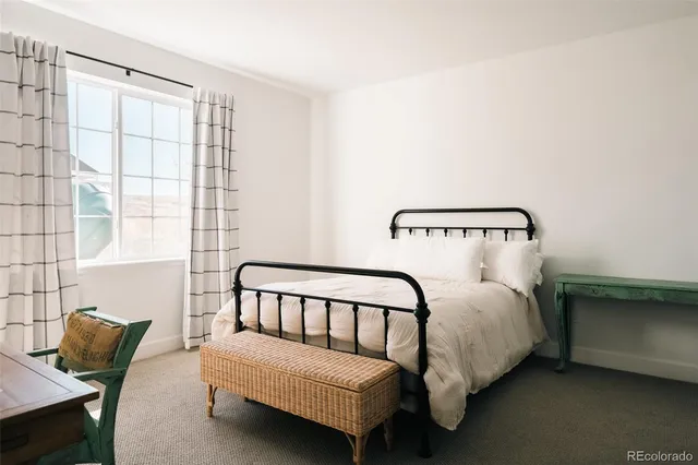 a bedroom with bed and a window
