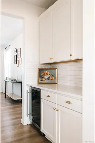 a kitchen with cabinets and a wooden floor