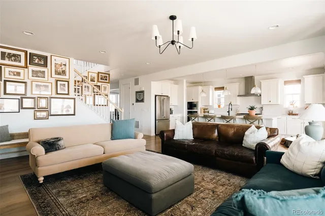 a living room with furniture wooden floor and a chandelier