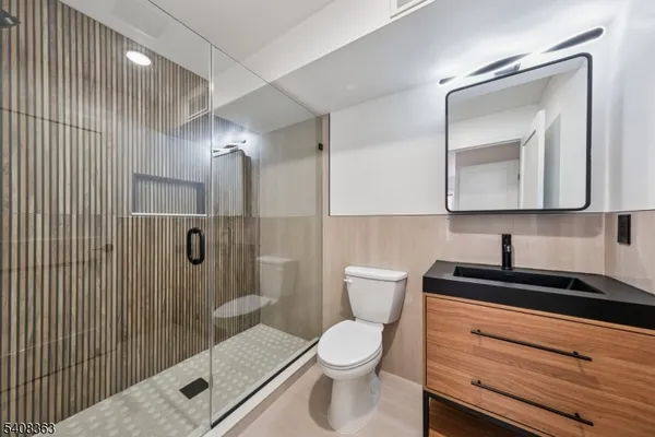a bathroom with a toilet a sink and shower