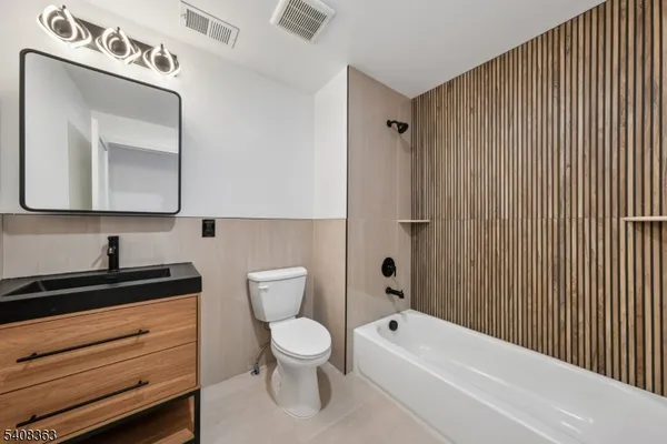 a bathroom with a toilet a sink and bathtub