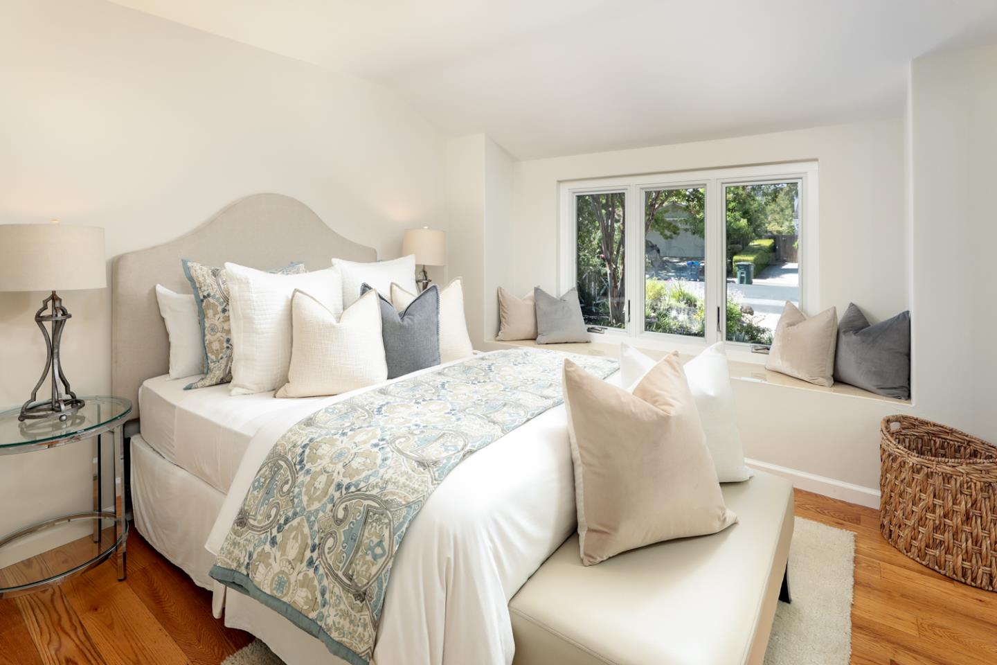 1869 Appletree Lane Mountain View, CA 94040 - Photo 15 of 35 a large bed sitting in a bedroom next to a window with lamp and a wooden floor