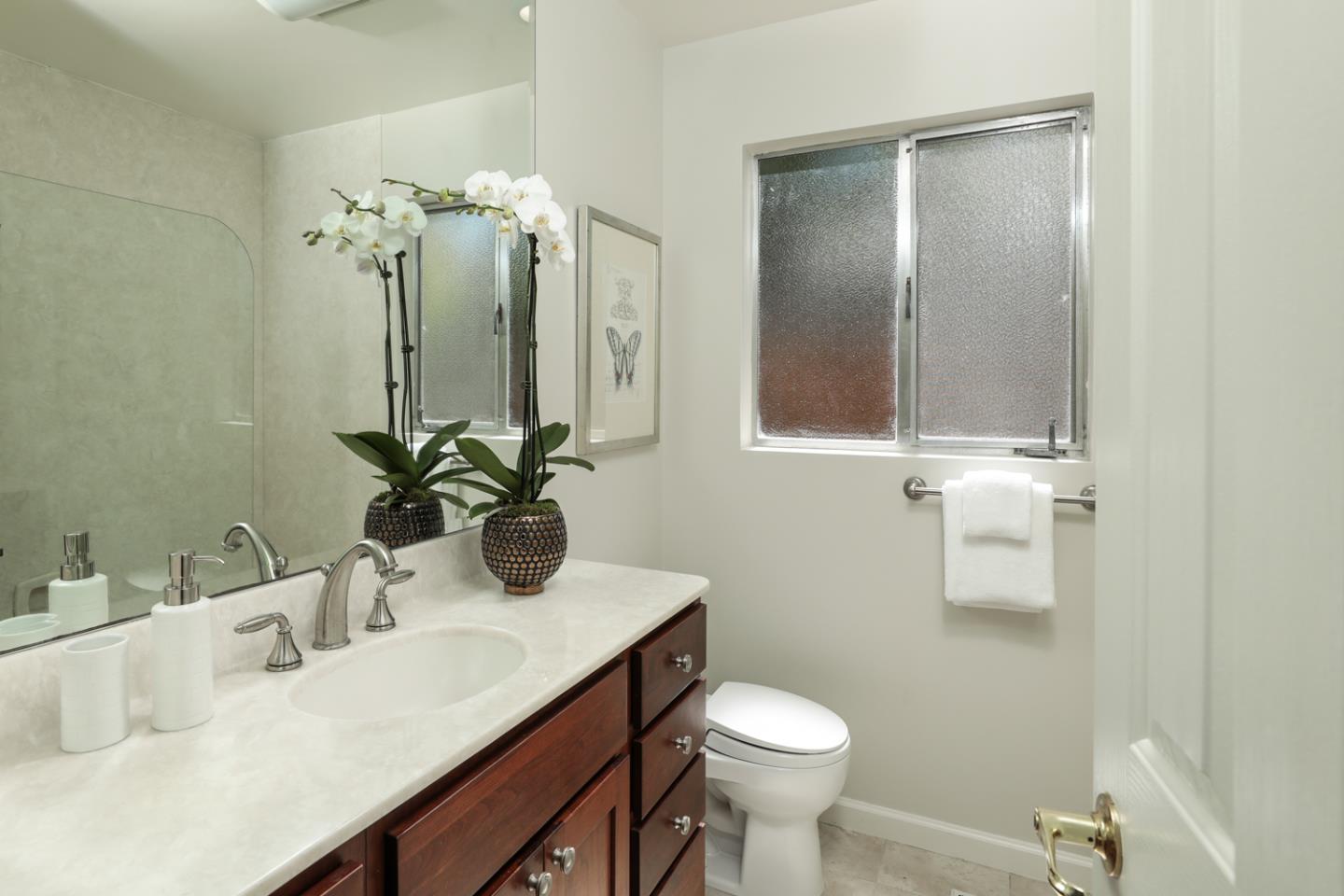1869 Appletree Lane Mountain View, CA 94040 - Photo 17 of 35 a bathroom with a sink a toilet and mirror