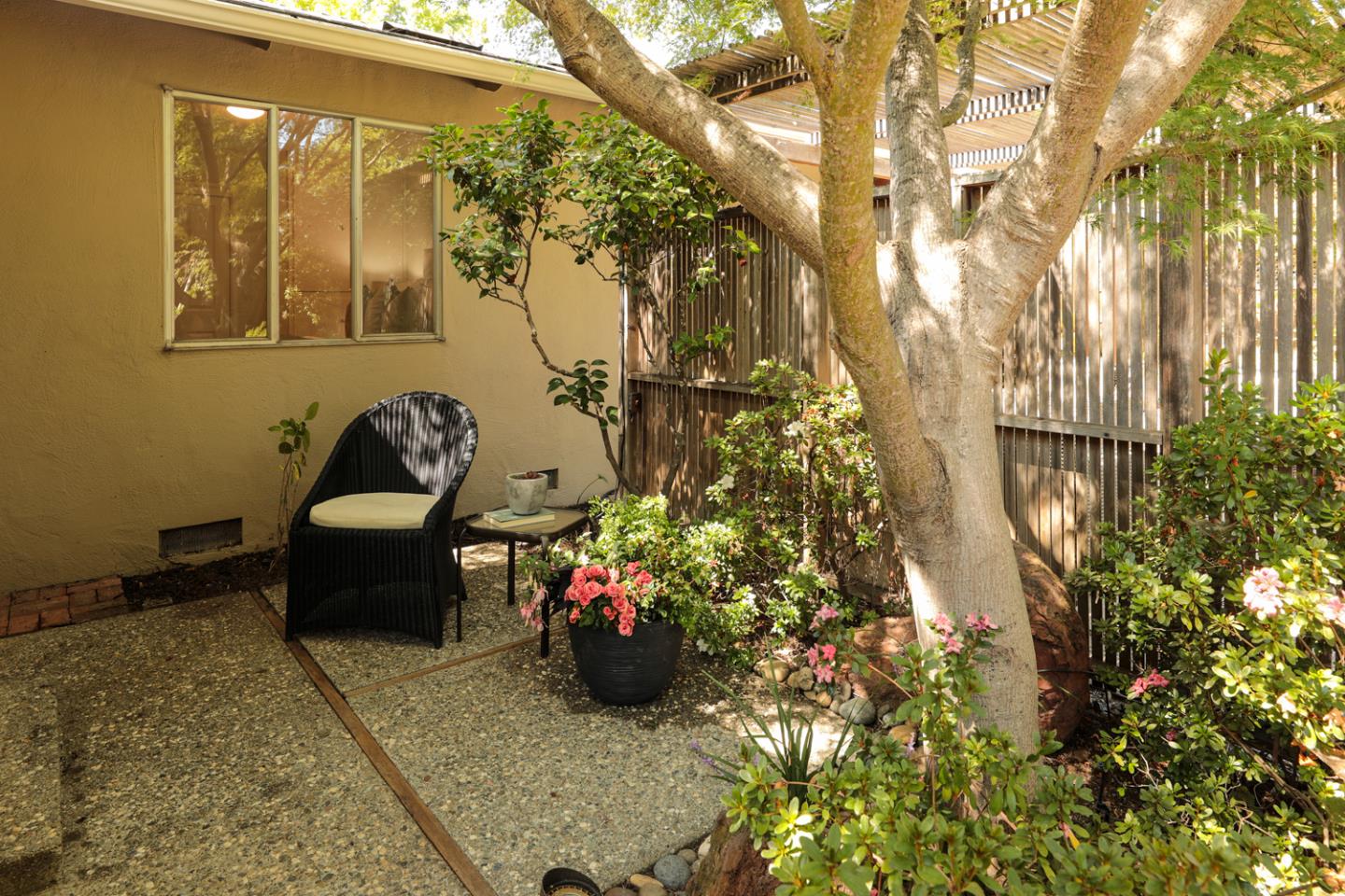 1869 Appletree Lane Mountain View, CA 94040 - Photo 21 of 35 a backyard of a house with table and chairs and potted plants