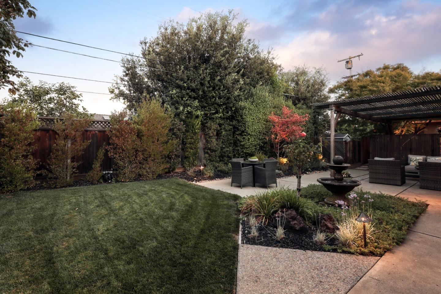 1869 Appletree Lane Mountain View, CA 94040 - Photo 24 of 35 a view of a patio with table and chairs potted plants and large tree