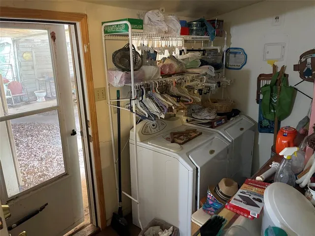 a kitchen with a refrigerator sink and white cabinets