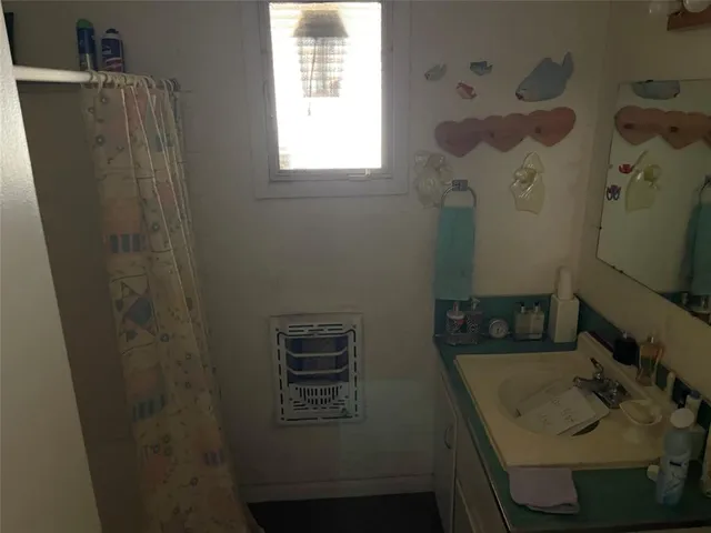 a bedroom with two beds and a window