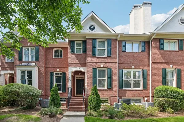 front view of a brick house with a yard