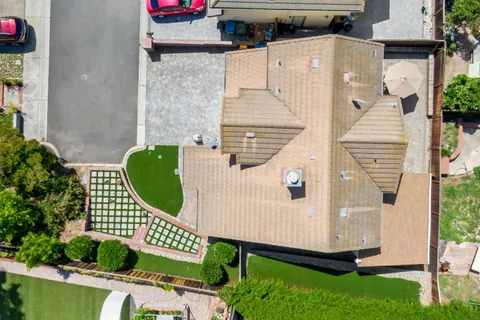 an aerial view of a house with garden space and stairs