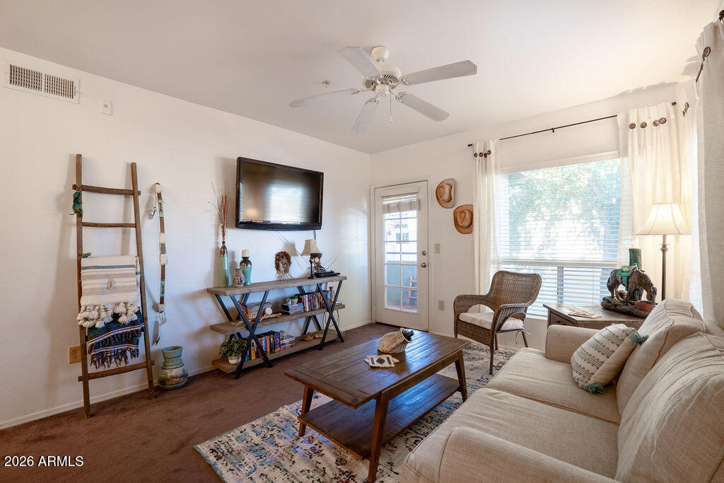 1825 West Ray Road, Unit 2120 Chandler, AZ 85224 - Photo 6 of 26 a living room with furniture and a flat screen tv