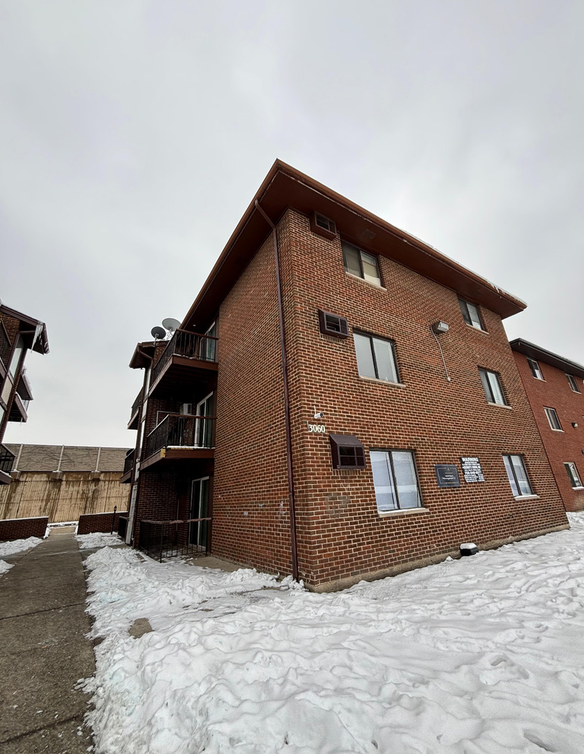 a view of a house with a snow in the background
