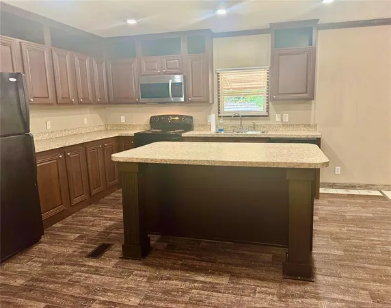 a room with a sink cabinets and wooden floor
