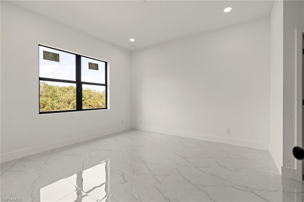 406 West 11th Street Lehigh Acres, FL 33972 - Photo 14 of 24 an empty room with windows