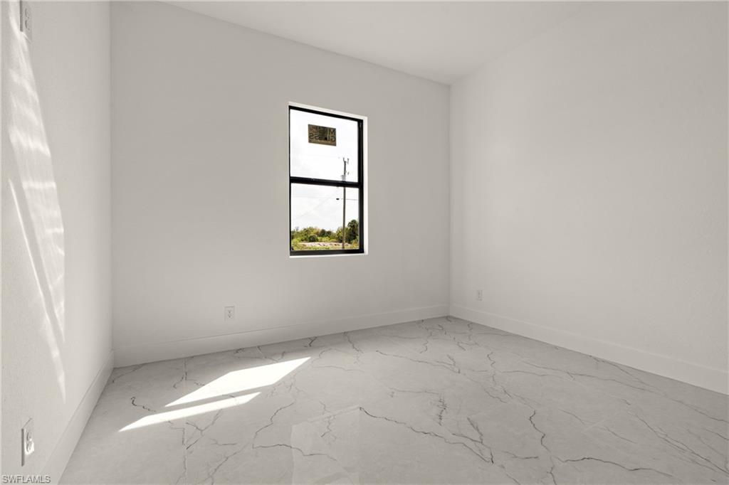 406 West 11th Street Lehigh Acres, FL 33972 - Photo 21 of 24 an empty room with a window
