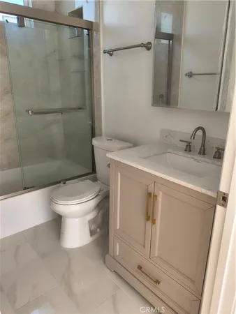 a white toilet sitting next to a bathroom sink