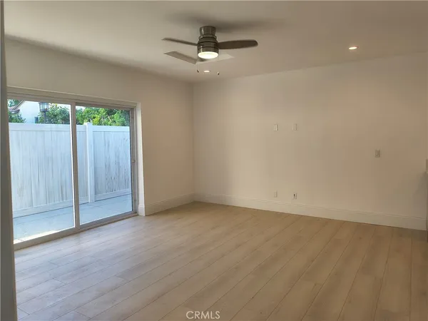 a large kitchen with a refrigerator a sink dishwasher a stove and a refrigerator with wooden floor