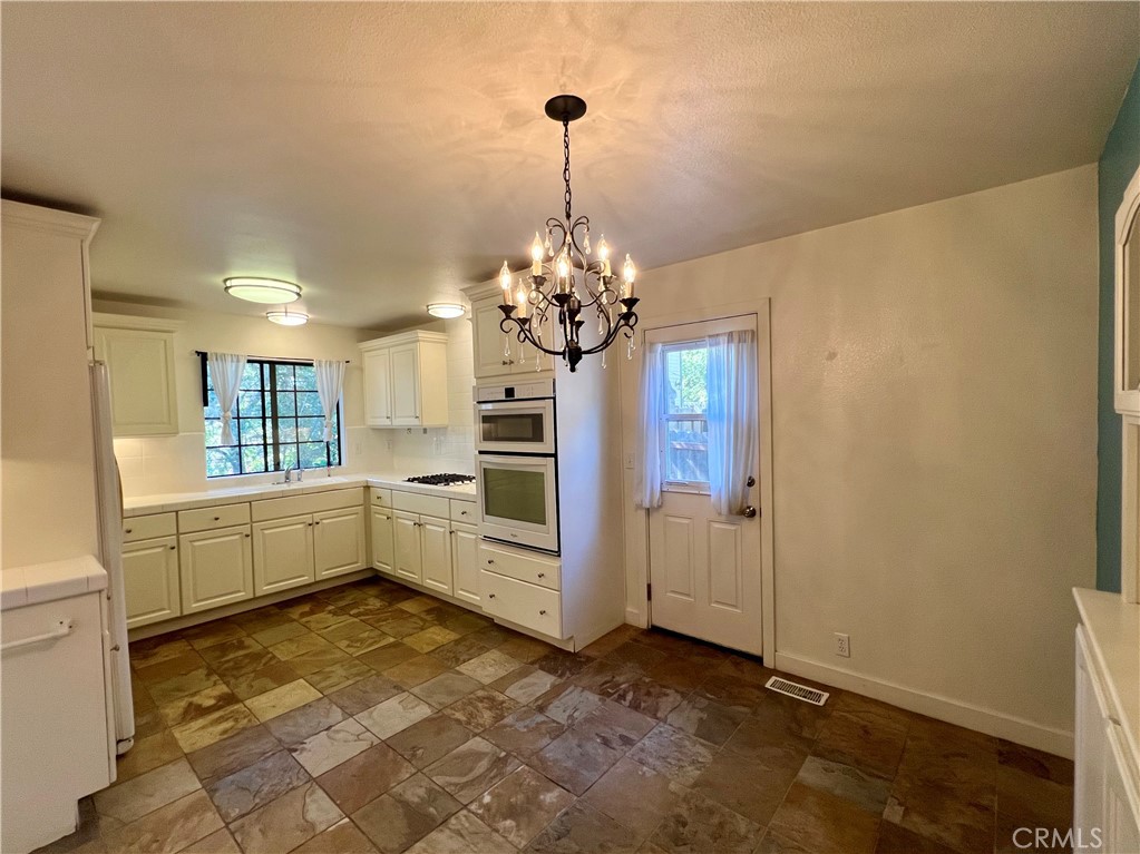 1530 Emerson Road Cambria, CA 93428 - Photo 12 of 54 Kitchen and dining area, with back door to side yard