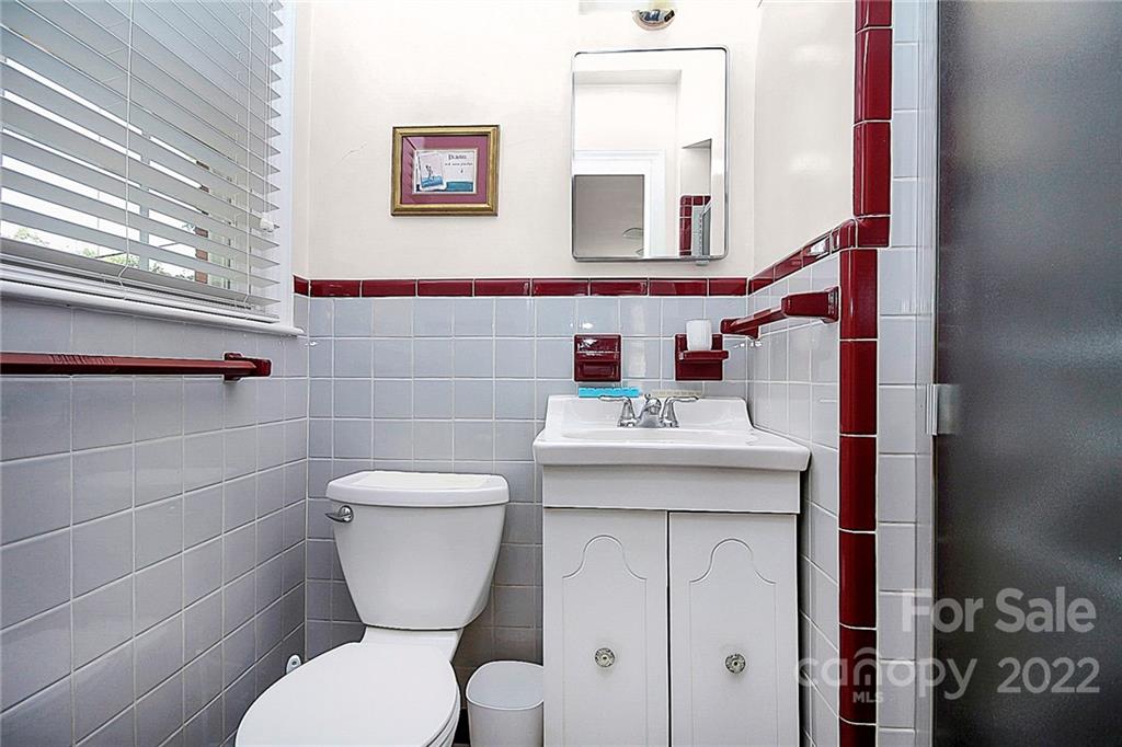 4114 Murrayhill Road Charlotte, NC 28209 - Photo 19 of 28 a bathroom with a toilet sink and mirror