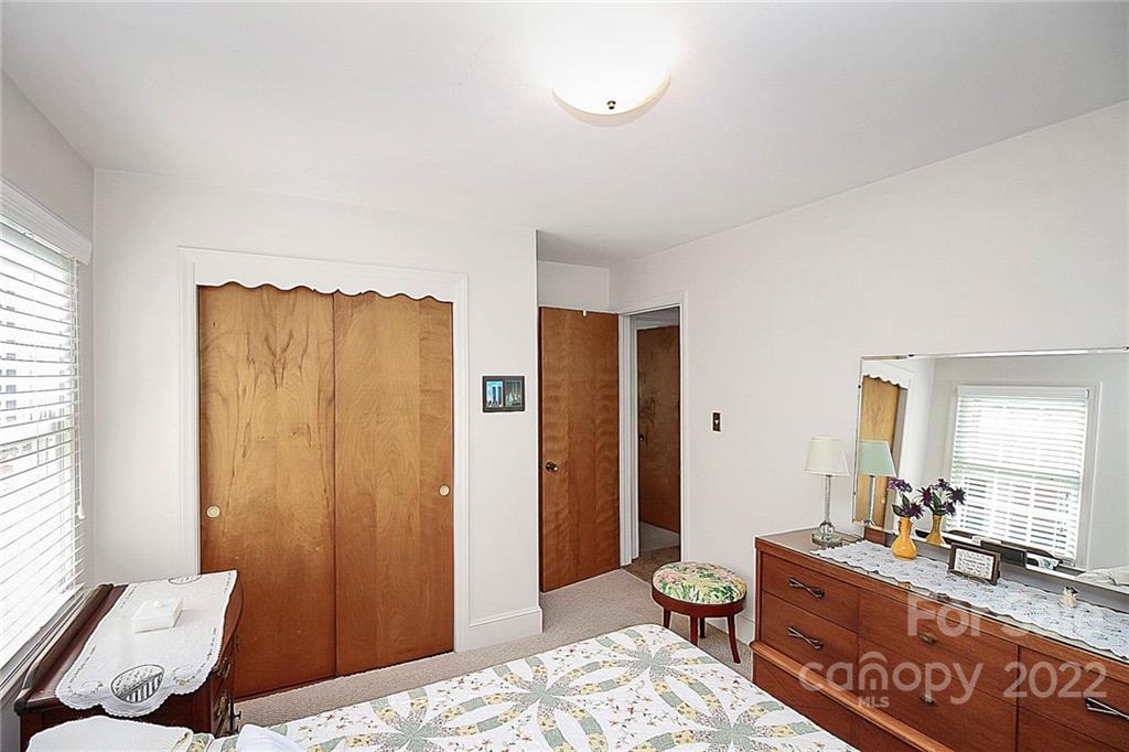 4114 Murrayhill Road Charlotte, NC 28209 - Photo 21 of 28 a bedroom with a bed and wooden floor